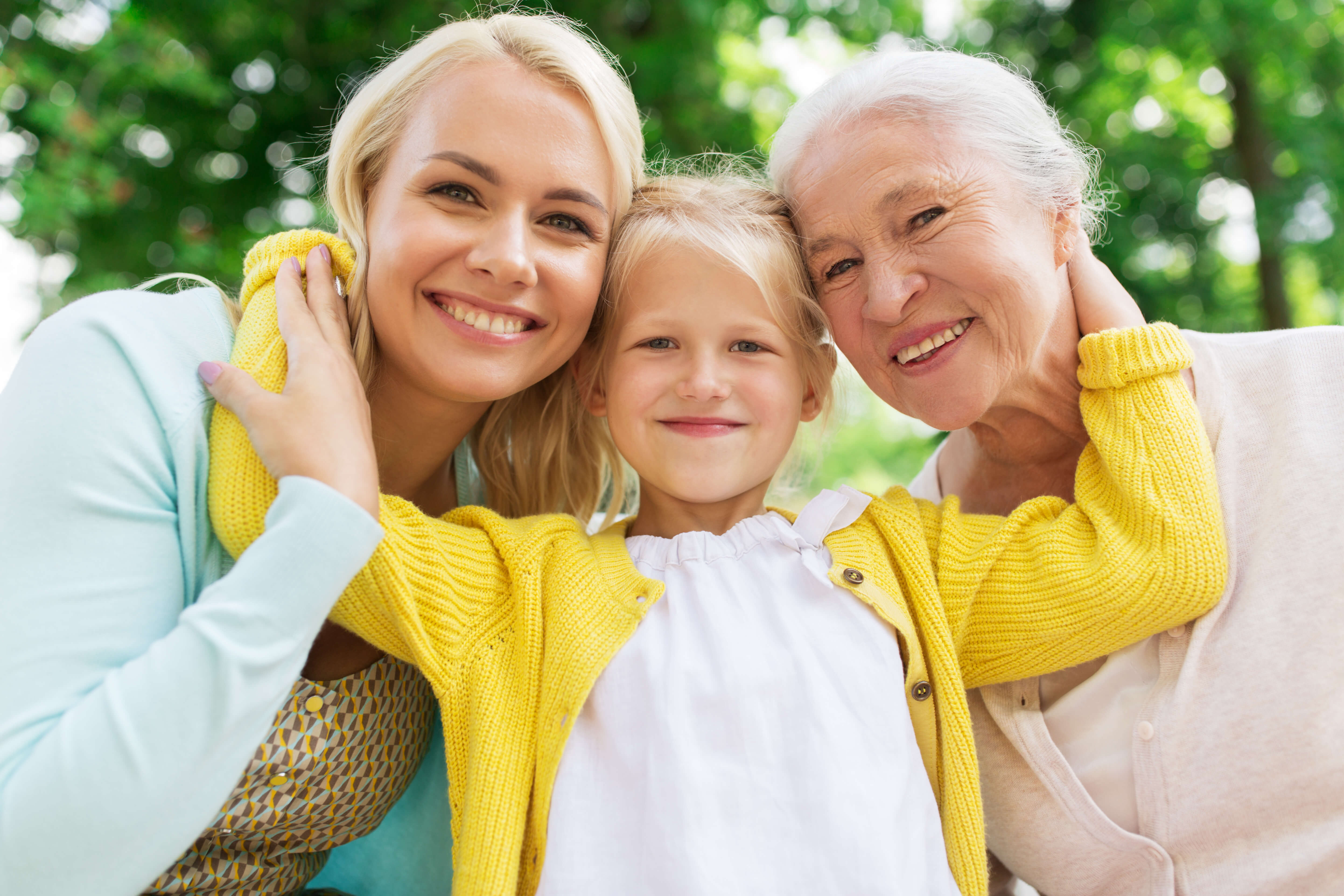 Mother, grandmother and young daughter taking picture together